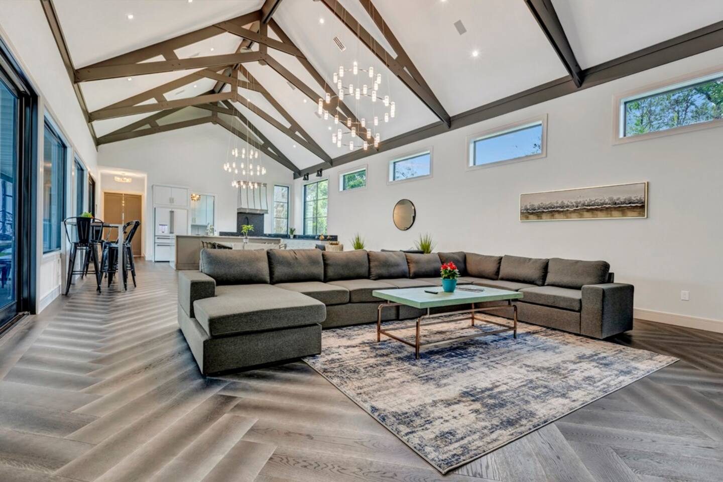 Take in the 20-foot vaulted ceilings, natural light, and elegant chandeliers in the grand room.
